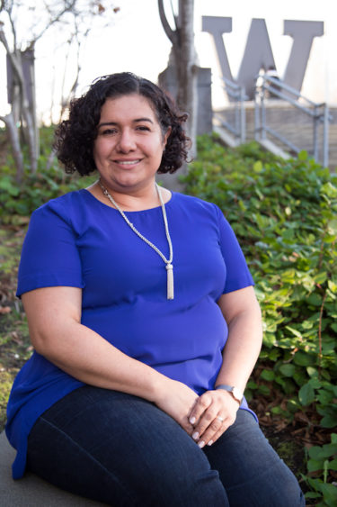 Carla Lopez-Wilkerson sits in front of the "Big W" on the UW Tacoma campus.