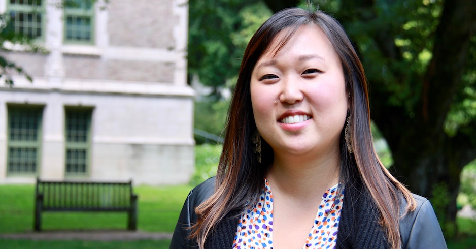 Saejin Kwak Tanguay stands under a tree on the quad.
