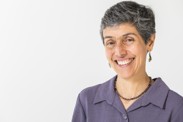 Tatiana Toro smiles wearing a light purple shirt